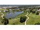 Scenic aerial view of a park featuring a pond, walking paths, and lush greenery, showcasing community recreation at 46 S Perry St, Denver, CO 80219