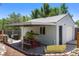 Charming backyard featuring a covered patio with seating, ideal for outdoor dining and enjoying the serene surroundings at 46 S Perry St, Denver, CO 80219