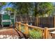 Fenced backyard with chicken coop, garden beds, and mature trees offers a private outdoor space at 46 S Perry St, Denver, CO 80219