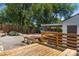 Large backyard with a wood deck, mature trees, and a storage shed at 46 S Perry St, Denver, CO 80219