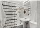 Bathroom features a pedestal sink, subway tile, and patterned shower curtain at 46 S Perry St, Denver, CO 80219