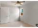 Bright bedroom with tile floors, two windows, neutral paint, and large closet at 46 S Perry St, Denver, CO 80219