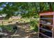 View of a community garden with various plants, a wooden shelf for book sharing, and a peaceful atmosphere at 46 S Perry St, Denver, CO 80219
