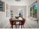 Bright dining room features natural light, tile floors, modern artwork, and seating for six at 46 S Perry St, Denver, CO 80219