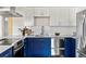 Updated kitchen featuring modern cabinets, stainless steel appliances and quartz countertops at 46 S Perry St, Denver, CO 80219