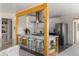 Modern kitchen with stainless steel appliances and a breakfast bar, open to the living room at 46 S Perry St, Denver, CO 80219