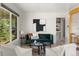 Bright living room with updated finishes, a large window, and stylish furnishings at 46 S Perry St, Denver, CO 80219