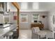 Open concept living and dining room area featuring updated tile flooring and decor at 46 S Perry St, Denver, CO 80219