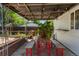 Covered patio with string lights, picnic table, and a lush outdoor garden at 46 S Perry St, Denver, CO 80219