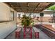 Covered patio area with string lights, wood table, and red benches offers a relaxing outdoor space at 46 S Perry St, Denver, CO 80219
