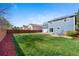 Large backyard with green grass, wood fence, and an outdoor patio, perfect for entertaining at 1444 S Richfield Way, Aurora, CO 80017