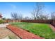 Wide shot of level backyard with wood fencing and mulch landscaping at 1444 S Richfield Way, Aurora, CO 80017