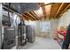 Unfinished basement area with exposed ceiling, appliances, and storage space at 1444 S Richfield Way, Aurora, CO 80017
