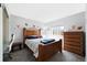 Cozy bedroom featuring wood furniture, sports themed decor, and a sunlit window at 1444 S Richfield Way, Aurora, CO 80017