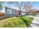 Street view of a charming blue single Gathering home with a two car garage and mature trees at 1444 S Richfield Way, Aurora, CO 80017