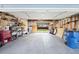 Spacious garage with ample storage and natural light, featuring organized shelving at 1444 S Richfield Way, Aurora, CO 80017