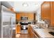 Well-lit kitchen with stainless steel appliances, wood cabinets, and tile backsplash at 1444 S Richfield Way, Aurora, CO 80017