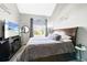 Cozy main bedroom featuring a plush bed, natural light, and backyard view at 1444 S Richfield Way, Aurora, CO 80017