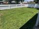 Well-kept backyard with a lush lawn and white fence, perfect for outdoor activities at 6660 Locust St, Commerce City, CO 80022
