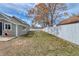 Spacious backyard featuring a white fence and view of home's exterior at 6660 Locust St, Commerce City, CO 80022