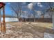 Spacious backyard featuring a canopy, wooden fence, and fire pit area, ideal for outdoor entertaining and relaxation at 6660 Locust St, Commerce City, CO 80022