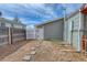 Backyard view showcasing a white gate and a partial view of the home's exterior at 6660 Locust St, Commerce City, CO 80022
