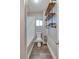 Bathroom featuring a shower-tub combo, wood-look floor, modern shelves, and white fixtures at 6660 Locust St, Commerce City, CO 80022