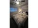 Cozy bedroom featuring a patterned comforter and soft, ambient lighting at 6660 Locust St, Commerce City, CO 80022