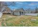 Charming single-story home featuring a well-manicured lawn and a white picket fence under a partly cloudy sky at 6660 Locust St, Commerce City, CO 80022