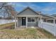 Charming single-story home featuring a covered front porch and classic architectural details with a white picket fence at 6660 Locust St, Commerce City, CO 80022