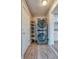 Efficient laundry area features stackable washer/dryer, shelving, and vinyl flooring at 6660 Locust St, Commerce City, CO 80022