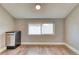 Versatile living space featuring wood-look flooring and a sun-filled window offering an open feel at 6660 Locust St, Commerce City, CO 80022