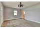 Inviting living room with plush carpet, natural light, and updated ceiling fixture at 6660 Locust St, Commerce City, CO 80022