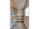 Pantry with wood-look floors, shelving on both sides, and a window with natural light at 6660 Locust St, Commerce City, CO 80022