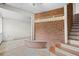 Basement area featuring a brick wall with a coat rack and stairs leading to the upper level at 7350 Field St, Arvada, CO 80005