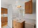 A bright bathroom with a wooden vanity, sink, toilet and a view into the shower at 7350 Field St, Arvada, CO 80005