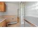 Bathroom featuring a glass block shower, vanity and toilet at 7350 Field St, Arvada, CO 80005