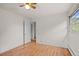 Bedroom features hardwood floors, white walls, and a doorway leading to another room at 7350 Field St, Arvada, CO 80005