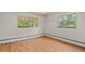 Sunlit bedroom featuring hardwood floors and two windows providing ample natural light at 7350 Field St, Arvada, CO 80005