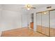 A bright bedroom with a ceiling fan, closet and hardwood floors at 7350 Field St, Arvada, CO 80005