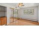 Bright bedroom features hardwood floors, a ceiling fan, and closet at 7350 Field St, Arvada, CO 80005