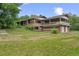 Spacious brick home featuring a charming covered balcony and a lush green lawn at 7350 Field St, Arvada, CO 80005
