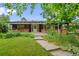 Charming single-story home with brick accents, a covered porch, and a well-maintained front yard at 7350 Field St, Arvada, CO 80005