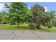Home with well-maintained front yard featuring mature trees and landscaping at 7350 Field St, Arvada, CO 80005