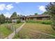 View of house with front yard and long covered porch area at 7350 Field St, Arvada, CO 80005