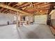 Large garage featuring concrete floors, exposed ceiling, a workbench, and a sizable overhead door at 7350 Field St, Arvada, CO 80005
