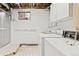 Laundry room features a vintage washer and dryer with tiled flooring and shower at 7350 Field St, Arvada, CO 80005