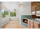 Bright living room featuring a large window, a fireplace, and hardwood floors at 7350 Field St, Arvada, CO 80005
