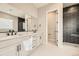 Modern bathroom with double vanity, black hardware, and tiled shower at 2978 Newfound Lake Rd, Berthoud, CO 80513