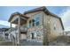 Modern home features a covered balcony, and a mix of stone and wood siding at 2978 Newfound Lake Rd, Berthoud, CO 80513